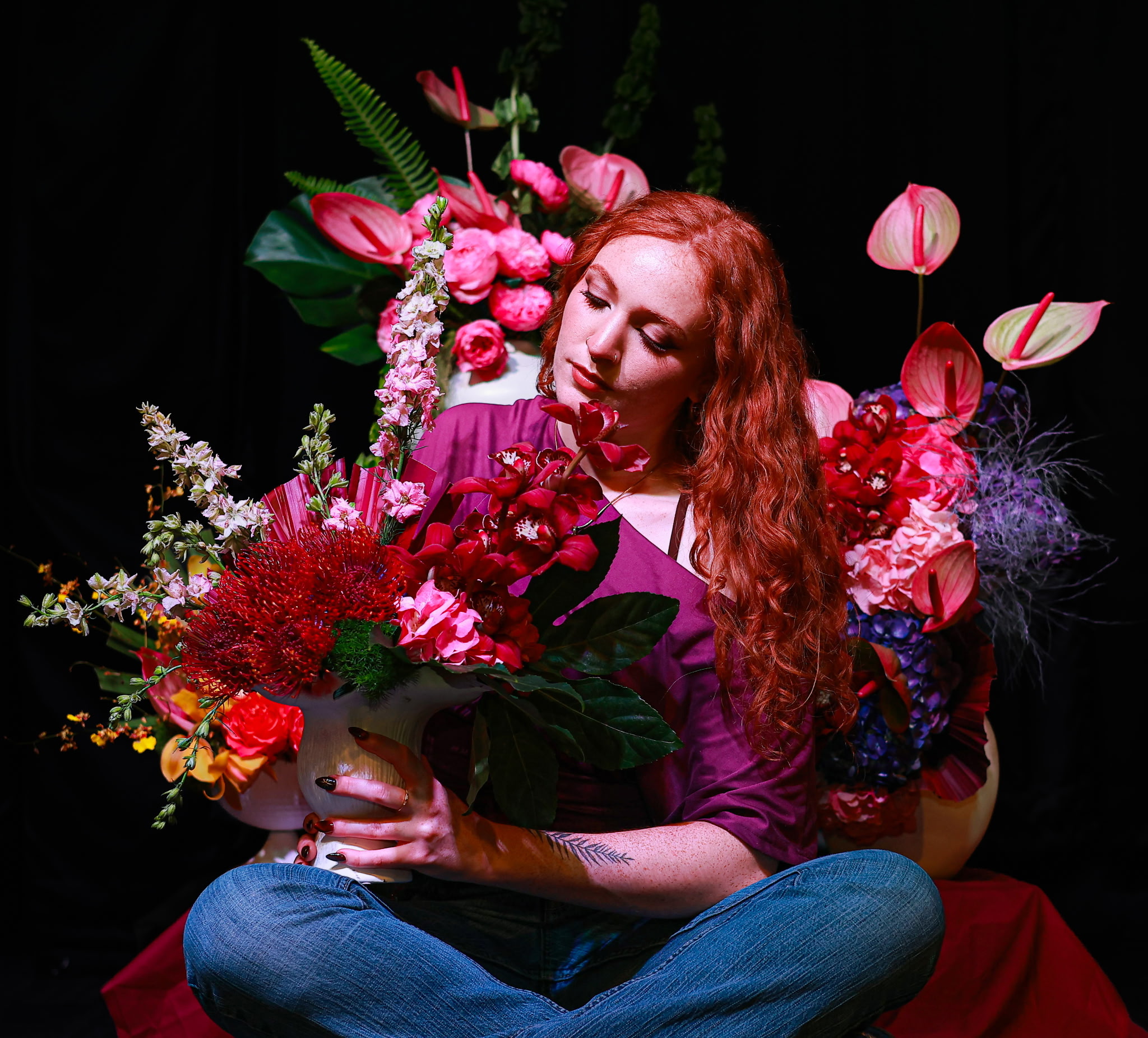 Caelan surrounded by her floral artwork